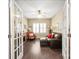Comfortable living room featuring wood floors, ceiling fan, stylish furniture, and lots of natural light at 8232 Bretton Woods Dr, Charlotte, NC 28227