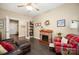 Living room features a decorative fireplace, hardwood floors, and cozy furniture at 8232 Bretton Woods Dr, Charlotte, NC 28227