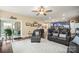 Open-concept living room featuring a ceiling fan and neutral color scheme with an adjacent kitchen at 8232 Bretton Woods Dr, Charlotte, NC 28227