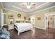 Cozy main bedroom featuring a ceiling fan, hardwood floors, and access to the main bathroom at 8232 Bretton Woods Dr, Charlotte, NC 28227