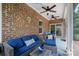 Relaxing screened porch with brick walls, comfortable seating, and ceiling fans at 8232 Bretton Woods Dr, Charlotte, NC 28227