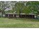 Charming single-story brick home nestled amidst mature trees on a well-manicured lawn at 8616 Fallsdale Dr, Charlotte, NC 28214