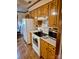 Cozy kitchen with white appliances, wooden cabinetry, and brick-patterned flooring at 8616 Fallsdale Dr, Charlotte, NC 28214