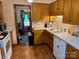 Kitchen features wooden cabinets, white appliances, and tile flooring at 8616 Fallsdale Dr, Charlotte, NC 28214