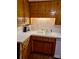 Kitchen with wood cabinets and white countertops featuring a double sink and stainless faucet at 8616 Fallsdale Dr, Charlotte, NC 28214