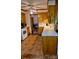Well-lit kitchen featuring white counters, ample cabinets, and brick-patterned flooring at 8616 Fallsdale Dr, Charlotte, NC 28214