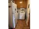 Laundry room featuring white appliances, tile flooring, and wooden cabinets at 8616 Fallsdale Dr, Charlotte, NC 28214