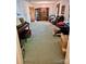 Spacious living room featuring a piano, large carpet, and wooden display case at 8616 Fallsdale Dr, Charlotte, NC 28214