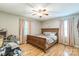 Cozy bedroom featuring hardwood floors, a ceiling fan, and natural light from two windows at 1005 Fieldstone Rd, Mooresville, NC 28115