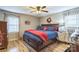 Comfortable bedroom with hardwood floors, a large bed, and natural light from two windows at 1005 Fieldstone Rd, Mooresville, NC 28115
