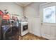 Laundry room featuring modern washer and dryer, with wainscoting at 1005 Fieldstone Rd, Mooresville, NC 28115