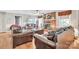 Inviting living room featuring hardwood floors, brick fireplace, and comfortable leather seating at 1005 Fieldstone Rd, Mooresville, NC 28115