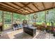 Cozy screened-in porch with string lights, rustic decor, and a serene view of the backyard at 1005 Fieldstone Rd, Mooresville, NC 28115