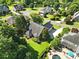 Aerial view of the neighborhood, home, and beautiful landscaping including mature trees at 104 Fairwind Ct, Fort Mill, SC 29708
