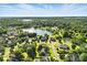 An aerial view of neighborhood featuring mature trees surrounding a lake at 104 Fairwind Ct, Fort Mill, SC 29708