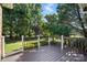 This backyard wooden deck features a wooden safety rail and a view of the green backyard at 104 Fairwind Ct, Fort Mill, SC 29708
