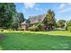 This lush backyard with thick green grass has plenty of space and is surrounded by large trees at 104 Fairwind Ct, Fort Mill, SC 29708