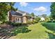 Lush green backyard and brick home exterior view with a wooden deck attached at 104 Fairwind Ct, Fort Mill, SC 29708