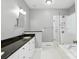 Bright bathroom featuring double vanity with granite counters and a glass-enclosed shower-tub combination at 104 Fairwind Ct, Fort Mill, SC 29708