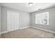 Neutral bedroom featuring carpet, double door closet and a window at 104 Fairwind Ct, Fort Mill, SC 29708
