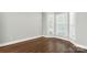 Bright bedroom featuring hardwood floors, large windows, and neutral walls at 104 Fairwind Ct, Fort Mill, SC 29708