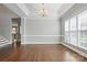 Spacious dining room boasts hardwood floors, tray ceilings, and abundant natural light from large windows at 104 Fairwind Ct, Fort Mill, SC 29708