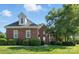 Charming red brick home featuring a lush front lawn and mature trees, creating a welcoming curb appeal at 104 Fairwind Ct, Fort Mill, SC 29708