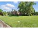 Beautiful brick home with a well-kept lawn and mature landscaping, showcasing the property's charm and curb appeal at 104 Fairwind Ct, Fort Mill, SC 29708