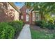 Inviting front entrance of a red brick home with a well-maintained walkway and manicured landscaping at 104 Fairwind Ct, Fort Mill, SC 29708