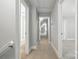 Hallway with carpet floors, multiple doorways, gray walls and white trim at 104 Fairwind Ct, Fort Mill, SC 29708