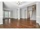 Spacious living room with hardwood floors, large windows, and a staircase at 104 Fairwind Ct, Fort Mill, SC 29708