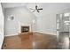 Spacious living room featuring a fireplace, ceiling fan, and hardwood floors at 104 Fairwind Ct, Fort Mill, SC 29708