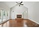 Bright living room with large windows, fireplace, and a ceiling fan at 104 Fairwind Ct, Fort Mill, SC 29708