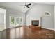 Open-concept living room with French doors, fireplace, and hardwood flooring at 104 Fairwind Ct, Fort Mill, SC 29708