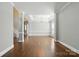 Open-concept living area with hardwood flooring, tray ceiling, and large windows for ample light at 104 Fairwind Ct, Fort Mill, SC 29708
