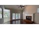Bright living room with a fireplace, tall ceiling with ceiling fan, and access to outdoor area at 104 Fairwind Ct, Fort Mill, SC 29708