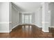 Spacious living room with hardwood floors, large windows, and detailed trim at 104 Fairwind Ct, Fort Mill, SC 29708