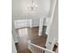 Open living room view from above featuring hardwood floors, large windows, and a decorative chandelier at 104 Fairwind Ct, Fort Mill, SC 29708