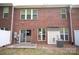 Red brick backyard with a concrete patio and sliding door entry to the house at 10433 Blairbeth St, Charlotte, NC 28277
