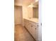 Bathroom with double sinks, a large mirror and neutral tiles at 10433 Blairbeth St, Charlotte, NC 28277