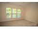 Bright, carpeted bedroom featuring three large windows letting in natural light at 10433 Blairbeth St, Charlotte, NC 28277