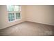 Carpeted bedroom featuring a large window letting in natural light at 10433 Blairbeth St, Charlotte, NC 28277