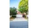 Brick home featuring a two-car garage, mature trees and manicured shrubs at 10433 Blairbeth St, Charlotte, NC 28277