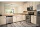 Kitchen featuring stainless steel appliances, granite counters, and a breakfast bar pass-through at 10433 Blairbeth St, Charlotte, NC 28277