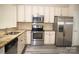 Updated kitchen with stainless steel appliances, granite countertops, and soft-close cabinets at 10433 Blairbeth St, Charlotte, NC 28277