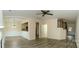 Open-concept living room with hardwood floors, wainscotting, and view of the kitchen and staircase at 10433 Blairbeth St, Charlotte, NC 28277