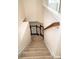 Carpeted staircase with wooden railing leading to the upper level at 10433 Blairbeth St, Charlotte, NC 28277