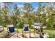 Landscaped backyard with a grill and patio seating, perfect for outdoor entertaining at 1133 Streamside Ln, York, SC 29745
