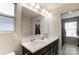 Elegant bathroom with a double sink vanity, large mirror, and a glimpse into a spacious walk-in closet at 1133 Streamside Ln, York, SC 29745