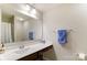 A well-lit bathroom with a vanity, large mirror, and a towel rack, ready for personal touches at 1133 Streamside Ln, York, SC 29745
